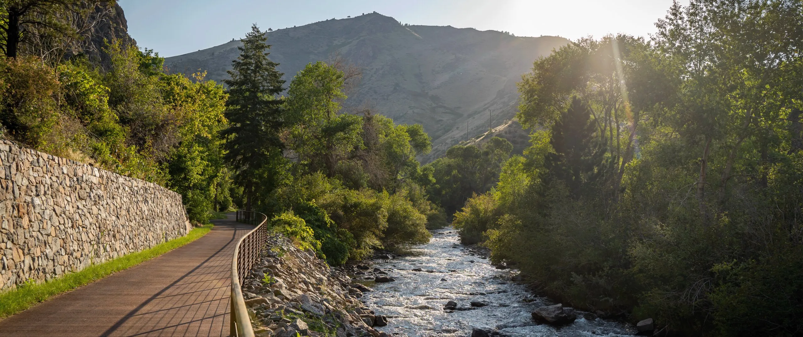 Clear Creek trail leading into Golden's foothills on a sunny afternoon.