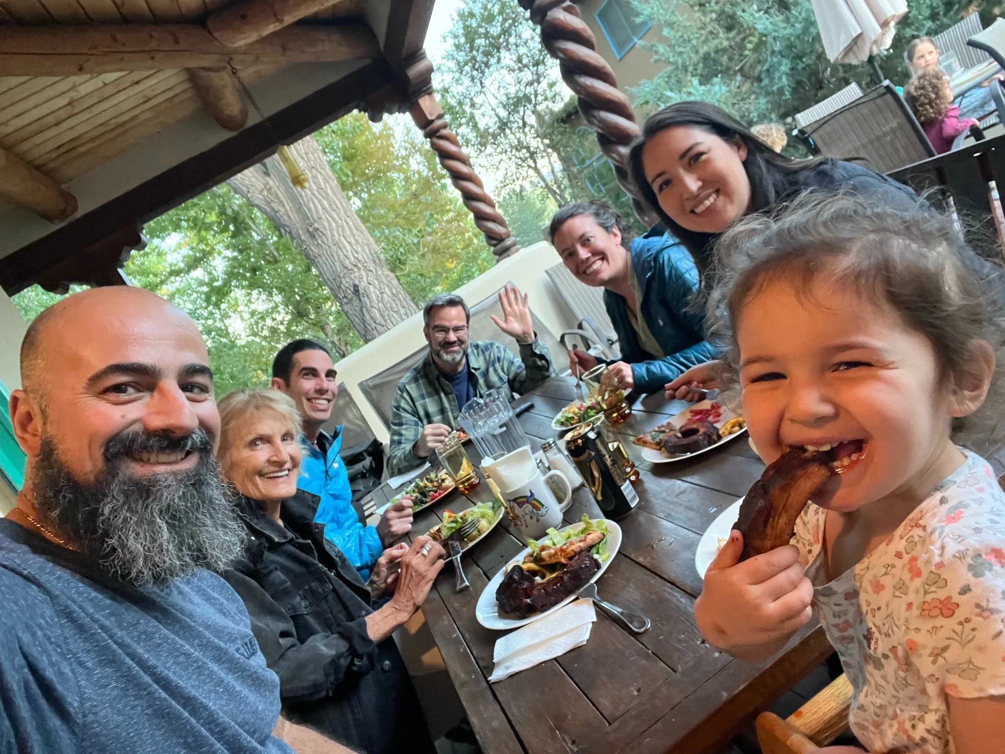 Overhead view of multigenerational community members sharing a meal together at a long table