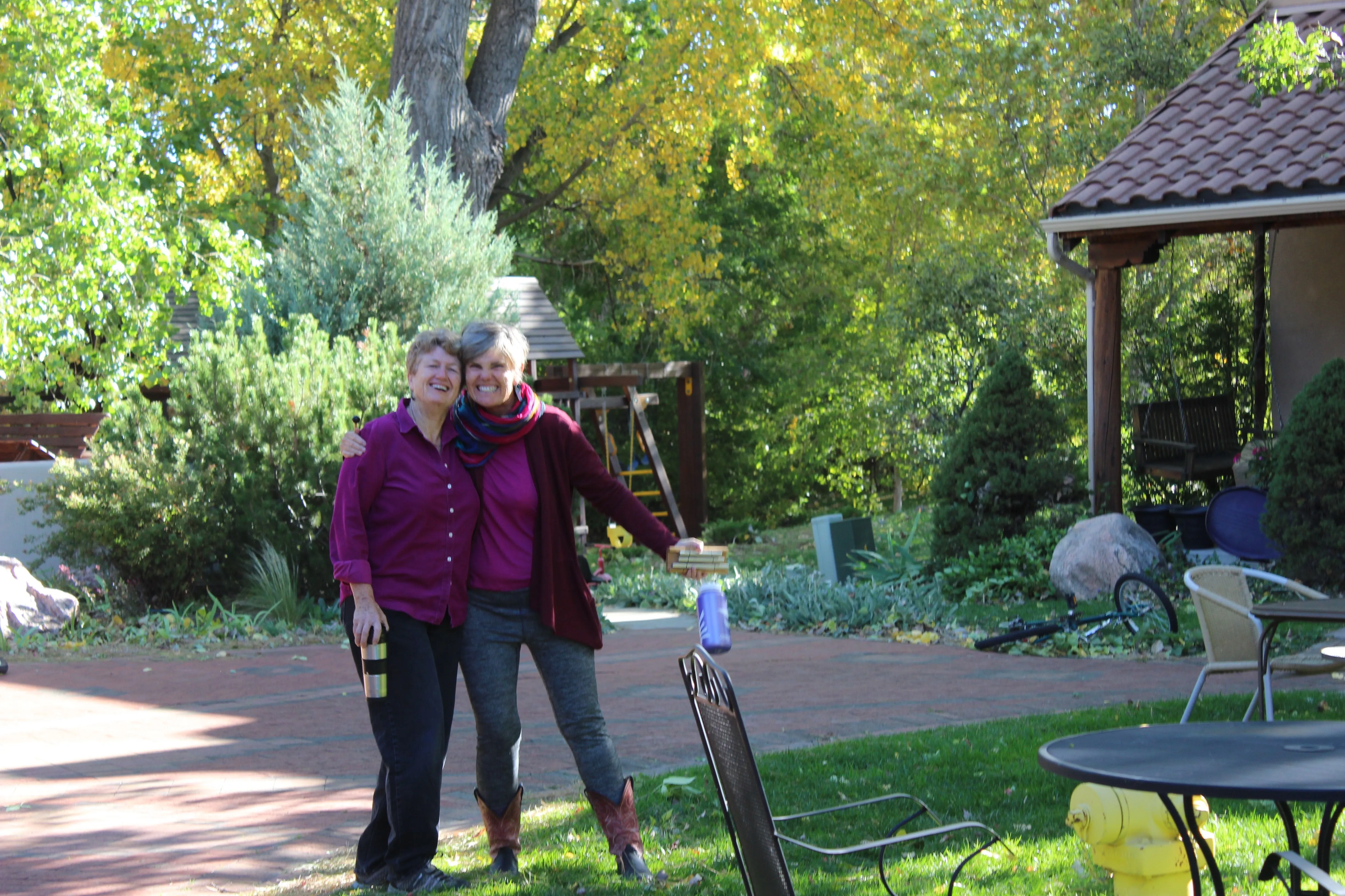 Two longtime residents walking together through the community garden and outdoor spaces